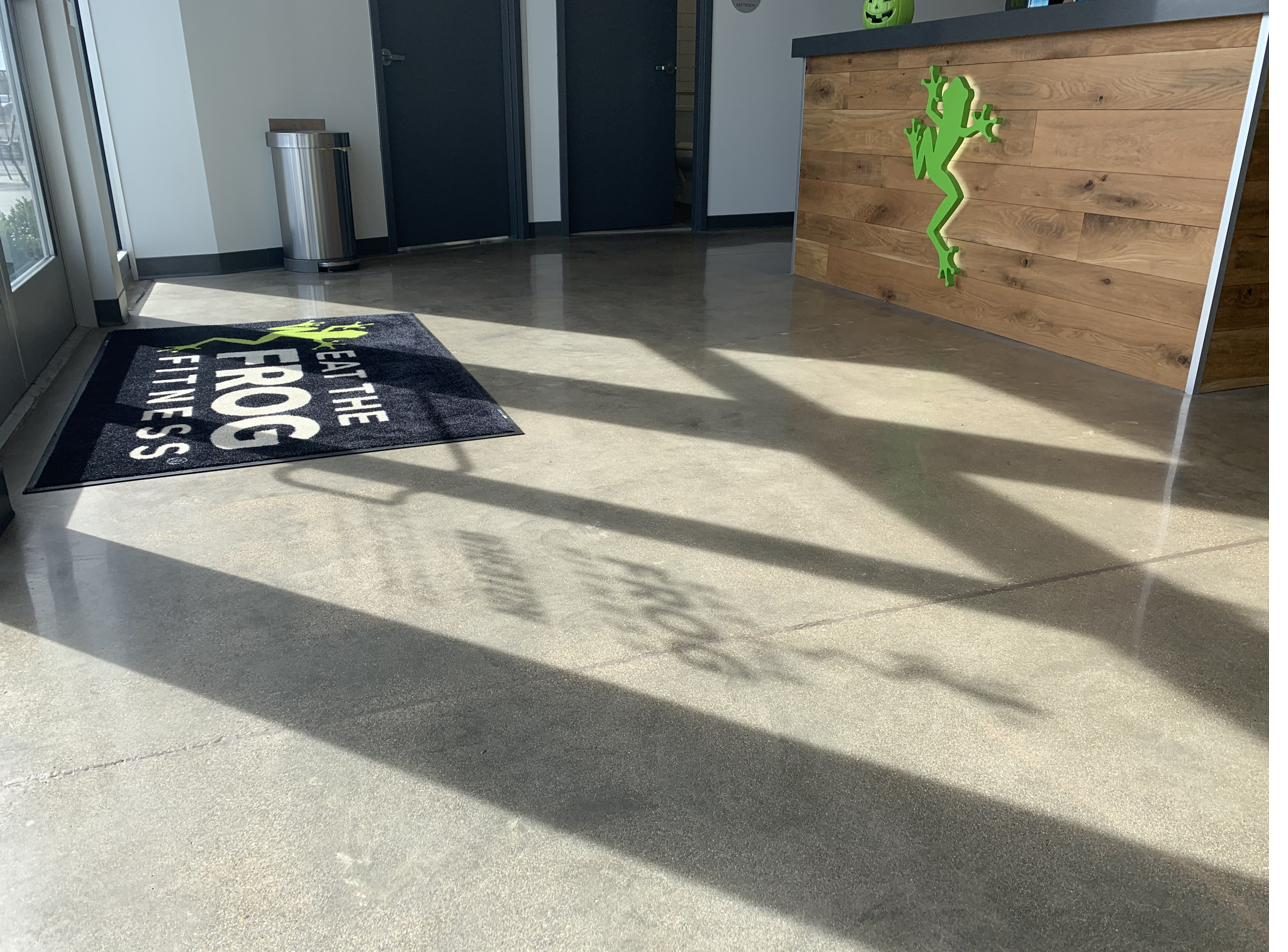 Polished concrete lobby floor at a fitness studio